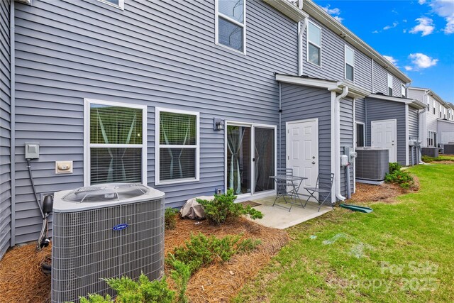 1563 Old Rivers Rd, Concord, NC 28027 - back of property with cooling unit, a patio, and a yard