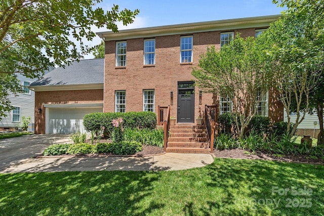 16028 Cranleigh Dr, Huntersville, NC 28078 - colonial home with brick siding, an attached garage, a front lawn, and concrete driveway