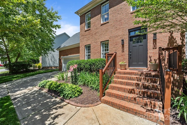 16028 Cranleigh Dr, Huntersville, NC 28078 - entrance to property featuring a garage, brick siding, and concrete driveway