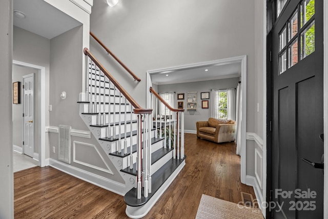16028 Cranleigh Dr, Huntersville, NC 28078 - foyer entrance featuring wood finished floors, stairs, ornamental molding, a high ceiling, and baseboards