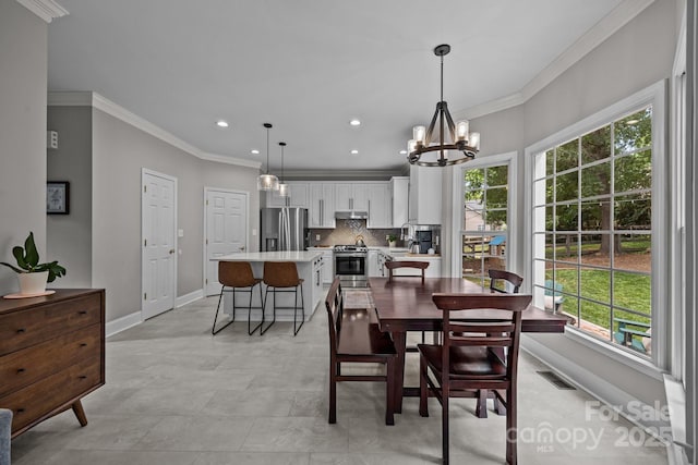 16028 Cranleigh Dr, Huntersville, NC 28078 - dining area featuring plenty of natural light, baseboards, crown molding, recessed lighting, and a chandelier