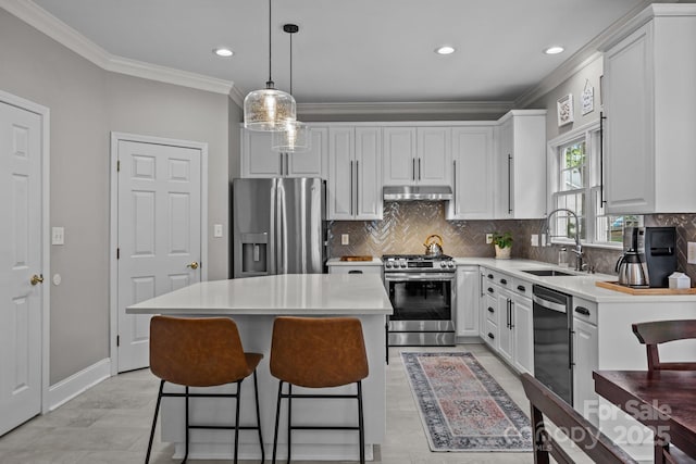 16028 Cranleigh Dr, Huntersville, NC 28078 - kitchen with appliances with stainless steel finishes, under cabinet range hood, a sink, a breakfast bar area, and ornamental molding