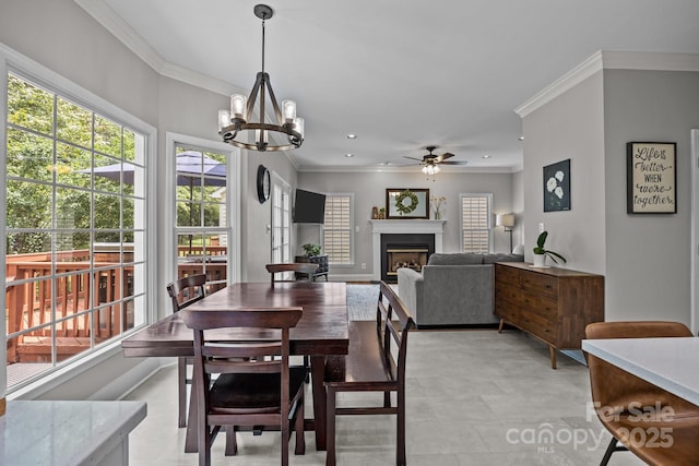 16028 Cranleigh Dr, Huntersville, NC 28078 - dining area featuring crown molding, a ceiling fan, a fireplace, a chandelier, and recessed lighting