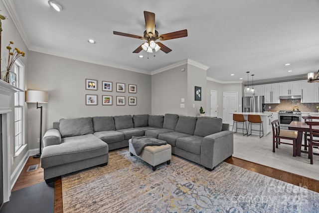 16028 Cranleigh Dr, Huntersville, NC 28078 - living area with wood finished floors, recessed lighting, a ceiling fan, and ornamental molding