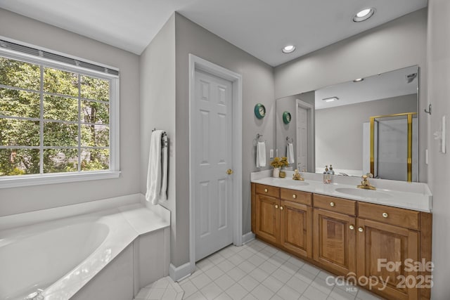 16028 Cranleigh Dr, Huntersville, NC 28078 - bathroom with tile patterned flooring, a bath, double vanity, a stall shower, and baseboards