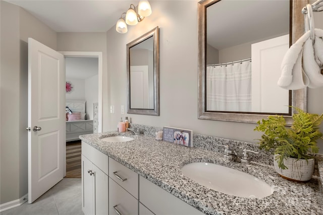 3009 Lydney Cir, Waxhaw, NC 28173 - bathroom featuring double vanity, tile patterned floors, and ensuite bathroom