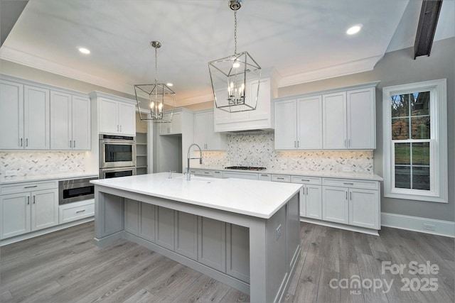 7215 Alexander Rd Unit 4, Charlotte, NC 28270 - kitchen with a chandelier, a sink, gas cooktop, light countertops, and tasteful backsplash