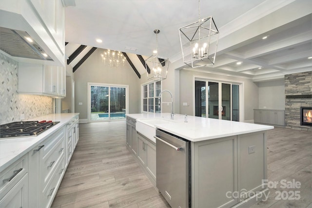 7215 Alexander Rd Unit 4, Charlotte, NC 28270 - kitchen featuring appliances with stainless steel finishes, custom range hood, a chandelier, beam ceiling, and a sink