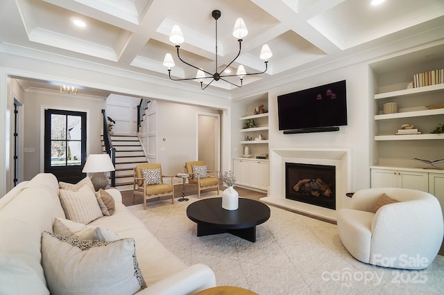 7215 Alexander Rd Unit 4, Charlotte, NC 28270 - living room with a chandelier, built in shelves, stairs, coffered ceiling, and a fireplace with raised hearth