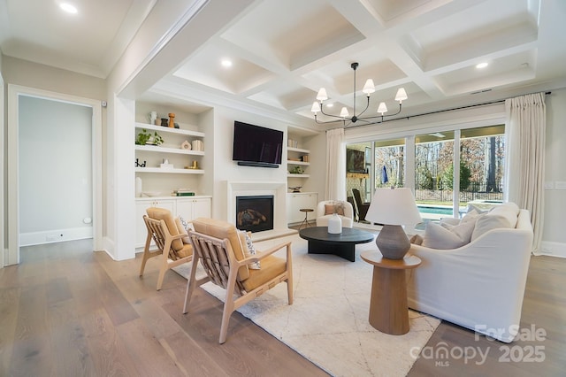 7215 Alexander Rd Unit 4, Charlotte, NC 28270 - living area with wood finished floors, a chandelier, recessed lighting, built in shelves, and a fireplace with raised hearth