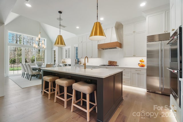 7215 Alexander Rd Unit 4, Charlotte, NC 28270 - kitchen with custom range hood, stainless steel built in fridge, light wood-style floors, white cabinets, and recessed lighting