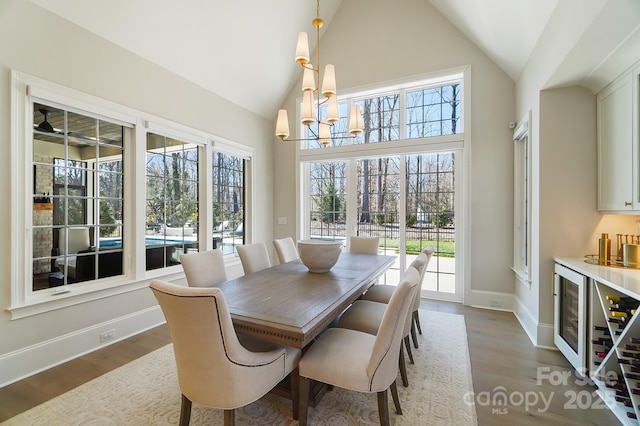 7215 Alexander Rd Unit 4, Charlotte, NC 28270 - dining space with a chandelier, beverage cooler, wood finished floors, baseboards, and high vaulted ceiling