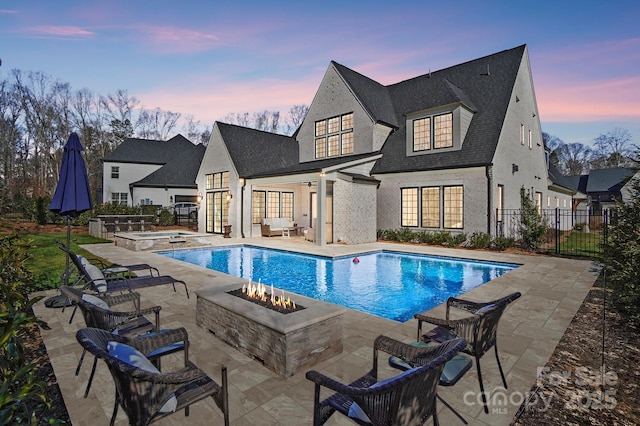 7215 Alexander Rd Unit 4, Charlotte, NC 28270 - pool at dusk with an in-ground hot tub, a patio, and an outdoor living space with a fire pit