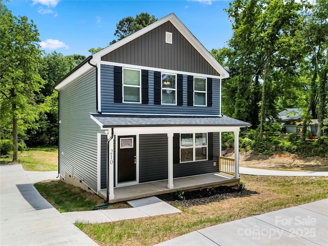 210 N Correll St, Landis, NC 28025 - view of front of house featuring a porch, board and batten siding, and roof with shingles