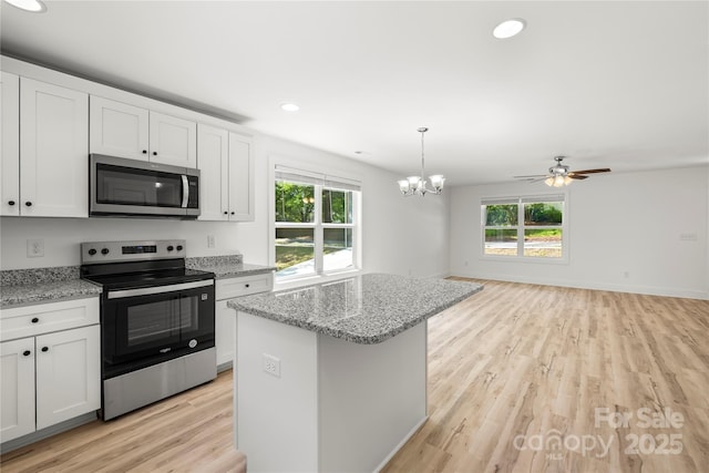 210 N Correll St, Landis, NC 28025 - kitchen featuring stainless steel appliances, light wood-type flooring, white cabinetry, a chandelier, and open floor plan
