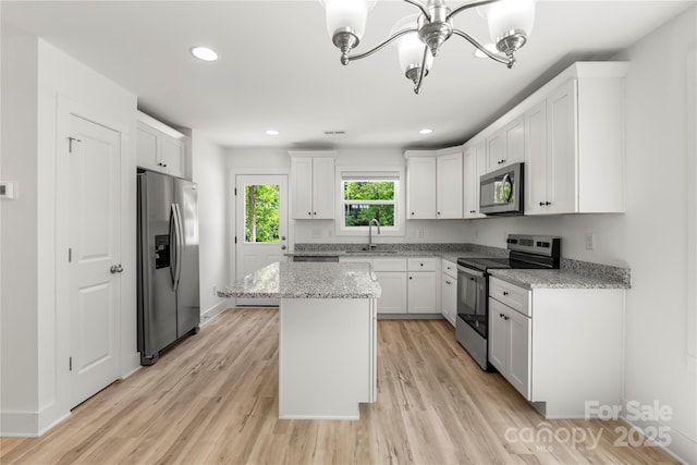 210 N Correll St, Landis, NC 28025 - kitchen featuring stainless steel appliances, a sink, white cabinetry, recessed lighting, and light wood-style floors