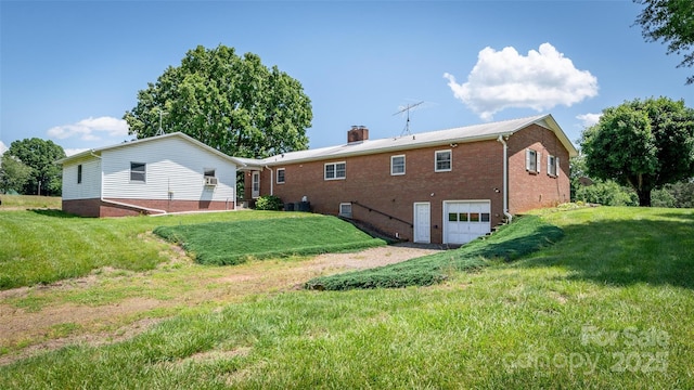 765 York Institute Rd, Hiddenite, NC 28636 - back of property with a garage, brick siding, a yard, and a chimney