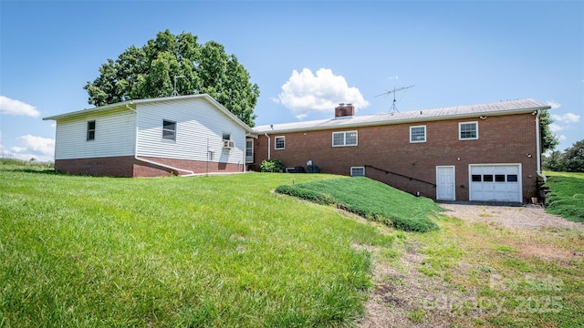 765 York Institute Rd, Hiddenite, NC 28636 - back of property featuring an attached garage, driveway, a chimney, a yard, and brick siding