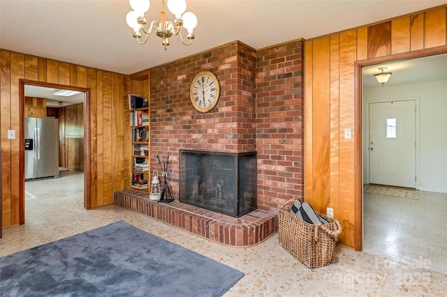 765 York Institute Rd, Hiddenite, NC 28636 - unfurnished living room featuring wood walls, a fireplace, and a chandelier
