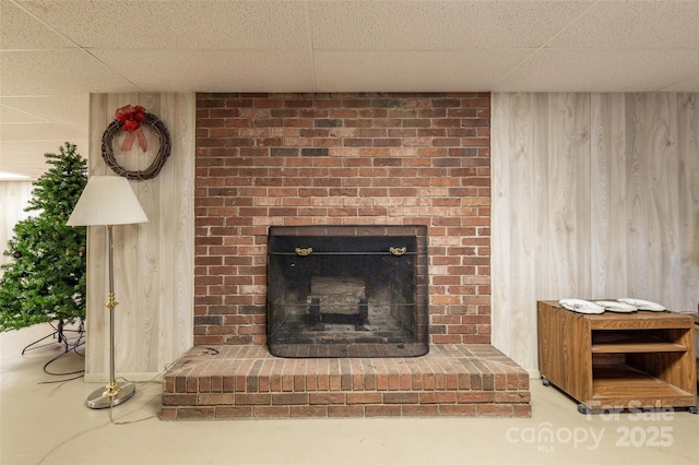 765 York Institute Rd, Hiddenite, NC 28636 - detailed view of wooden walls, a drop ceiling, a brick fireplace, and finished concrete flooring