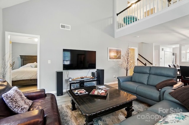 3071 Des Prez Ave, Fort Mill, SC 29707 - living room with a high ceiling, stairs, wood finished floors, and baseboards
