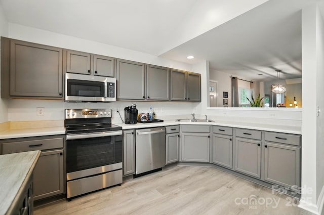 3071 Des Prez Ave, Fort Mill, SC 29707 - kitchen with appliances with stainless steel finishes, gray cabinetry, light wood finished floors, light countertops, and recessed lighting