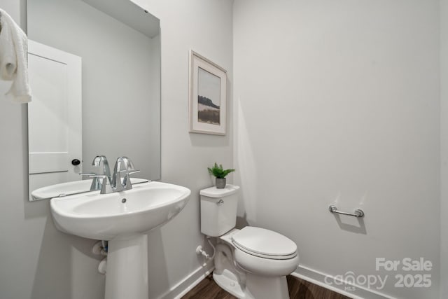 3034 Finchborough Ct Unit 233, Charlotte, NC 28269 - half bathroom with baseboards, wood finished floors, toilet, and a sink