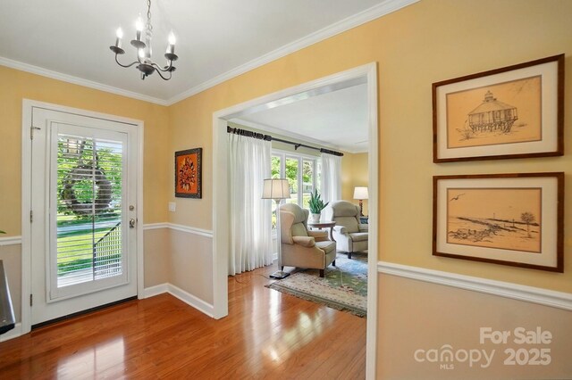 308 Odell St, Kannapolis, NC 28083 - doorway to outside with wood finished floors, a chandelier, ornamental molding, and baseboards