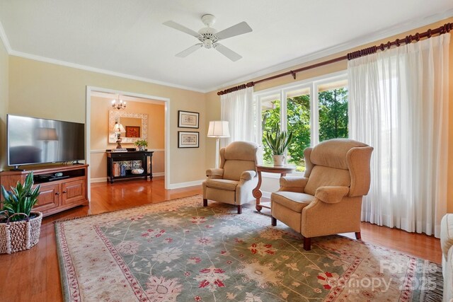 308 Odell St, Kannapolis, NC 28083 - living area featuring crown molding, wood finished floors, ceiling fan, a chandelier, and baseboards