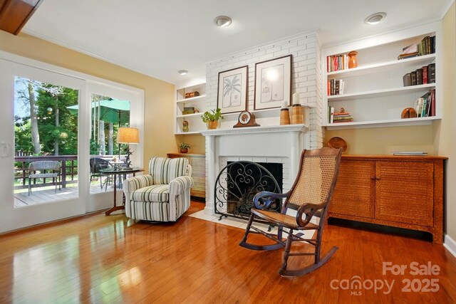 308 Odell St, Kannapolis, NC 28083 - sitting room featuring wood finished floors, a fireplace, and built in features