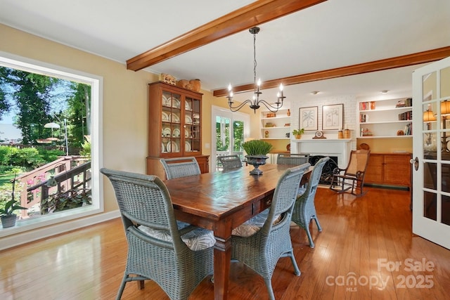 308 Odell St, Kannapolis, NC 28083 - dining space featuring a chandelier, beamed ceiling, hardwood / wood-style floors, a fireplace, and ornamental molding