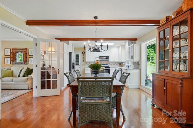 308 Odell St, Kannapolis, NC 28083 - dining space with a chandelier, beam ceiling, and light wood-style floors
