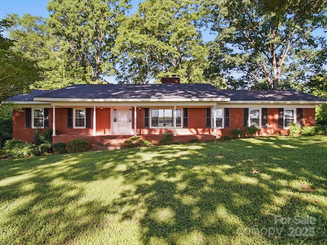 2216 Griffith Rd, Monroe, NC 28112 - ranch-style house with brick siding, a front yard, a chimney, and a porch