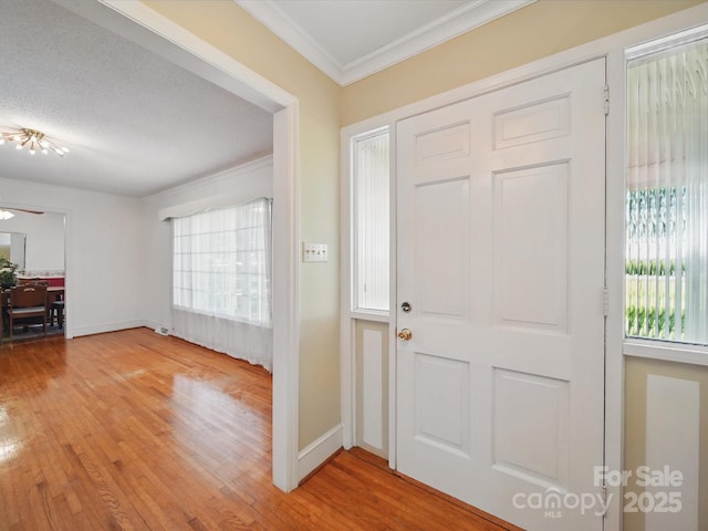 2216 Griffith Rd, Monroe, NC 28112 - entrance foyer with ornamental molding, healthy amount of natural light, light wood-style floors, and baseboards