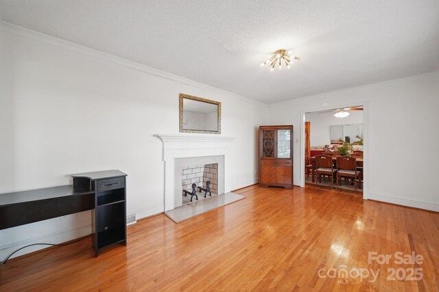 2216 Griffith Rd, Monroe, NC 28112 - living room with a fireplace, wood finished floors, ornamental molding, and baseboards
