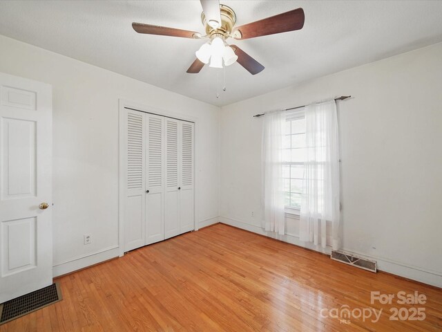 2216 Griffith Rd, Monroe, NC 28112 - unfurnished bedroom with wood finished floors, baseboards, a closet, and ceiling fan