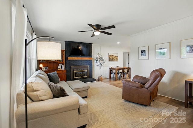 103 W Sunset Dr, Locust, NC 28097 - living area with ceiling fan, wood finished floors, a fireplace, and crown molding