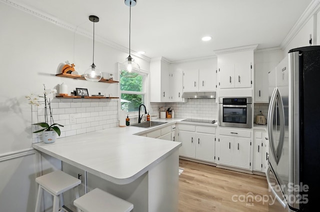 103 W Sunset Dr, Locust, NC 28097 - kitchen featuring appliances with stainless steel finishes, a sink, a peninsula, tasteful backsplash, and ornamental molding