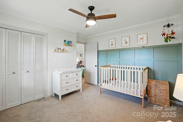 103 W Sunset Dr, Locust, NC 28097 - carpeted bedroom with crown molding, a closet, a nursery area, a decorative wall, and a ceiling fan