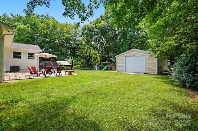 103 W Sunset Dr, Locust, NC 28097 - view of green lawn with a patio area, a playground, an outdoor fire pit, central air condition unit, and view of scattered trees