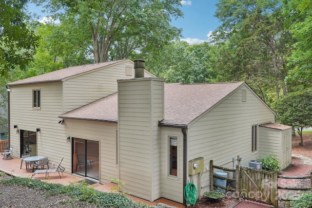 8117 Rising Meadow Rd, Charlotte, NC 28277 - back of house featuring a shingled roof, a chimney, a wooden deck, and a gate