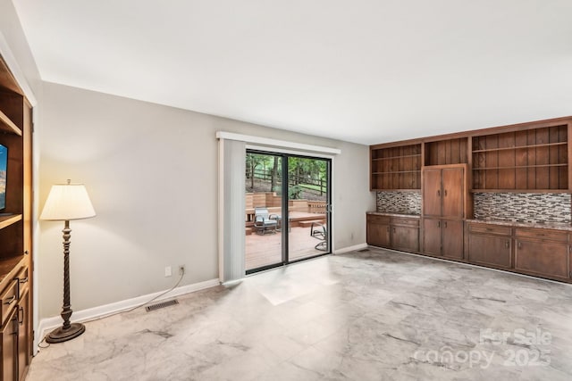 8117 Rising Meadow Rd, Charlotte, NC 28277 - unfurnished living room with baseboards and light marble finish flooring