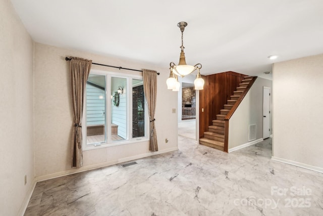 8117 Rising Meadow Rd, Charlotte, NC 28277 - unfurnished dining area featuring marble finish floors, stairs, and baseboards