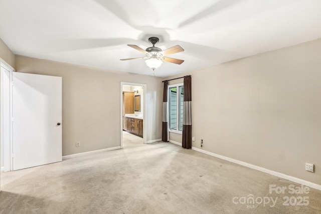 8117 Rising Meadow Rd, Charlotte, NC 28277 - unfurnished bedroom featuring light carpet, baseboards, connected bathroom, and ceiling fan