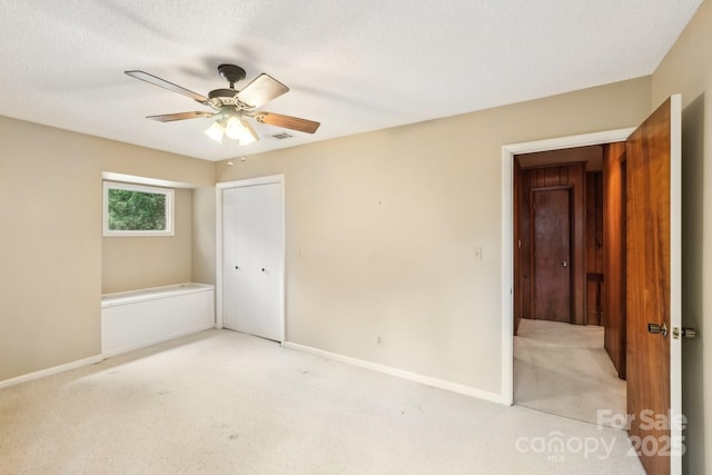 8117 Rising Meadow Rd, Charlotte, NC 28277 - unfurnished bedroom with light colored carpet, a closet, baseboards, and a textured ceiling