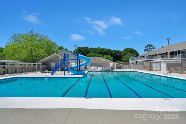 8117 Rising Meadow Rd, Charlotte, NC 28277 - community pool with a water slide and view of wooded area