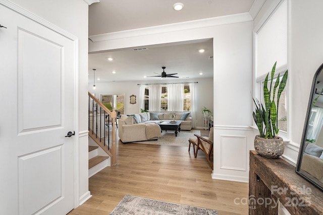 16018 River Tree Ln, Charlotte, NC 28278 - living room featuring stairway, light wood-type flooring, ceiling fan, recessed lighting, and crown molding