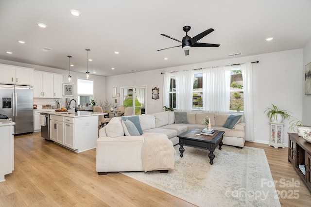 16018 River Tree Ln, Charlotte, NC 28278 - living area featuring light wood finished floors, recessed lighting, a ceiling fan, and baseboards