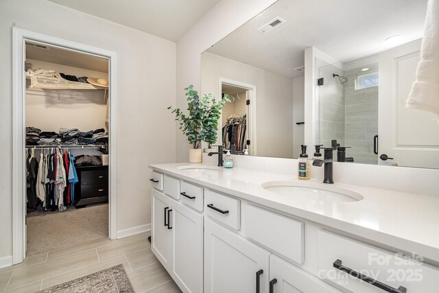 16018 River Tree Ln, Charlotte, NC 28278 - full bath featuring a spacious closet, double vanity, a shower stall, baseboards, and tile patterned floors