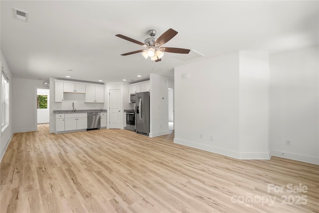 212 N Correll St, Landis, NC 28025 - unfurnished living room featuring a ceiling fan, baseboards, light wood finished floors, a sink, and recessed lighting